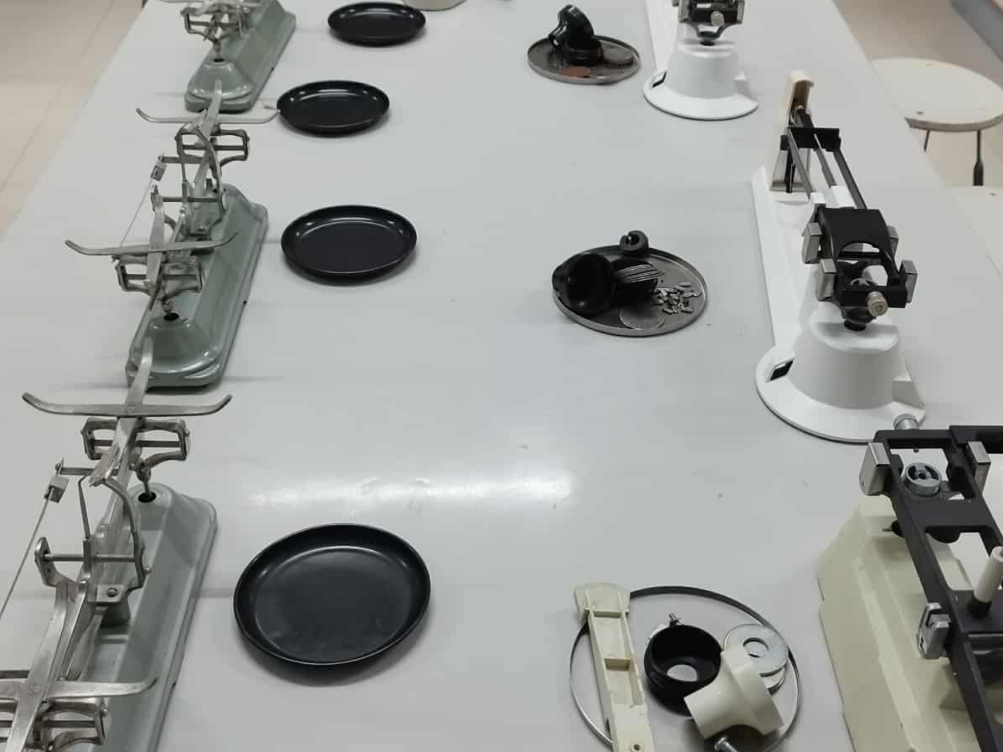 Disassembled double and triple beam balances on workbench