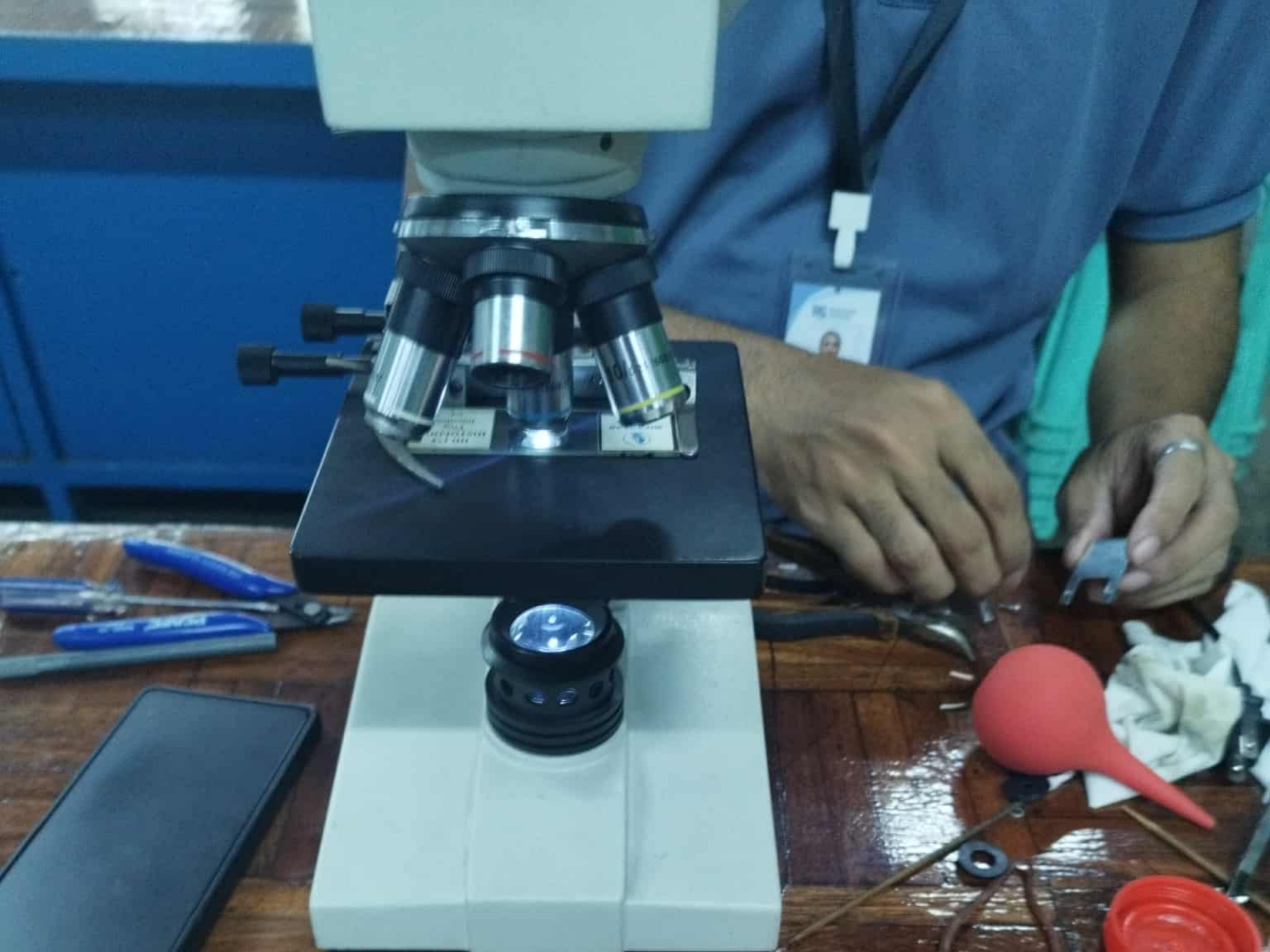 Technician performing microscope quality check